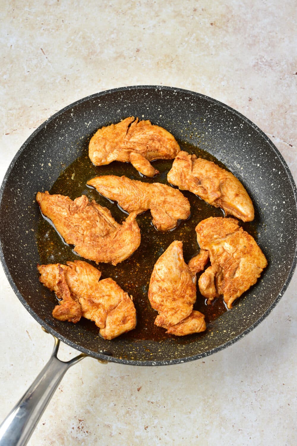 chicken frying in a pan