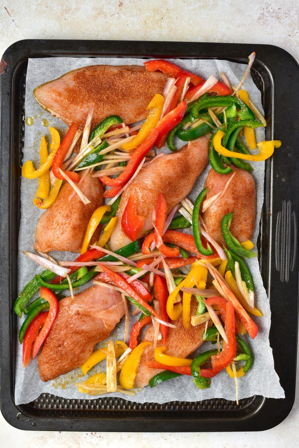 chicken fajitas on sheet pan ready for the oven