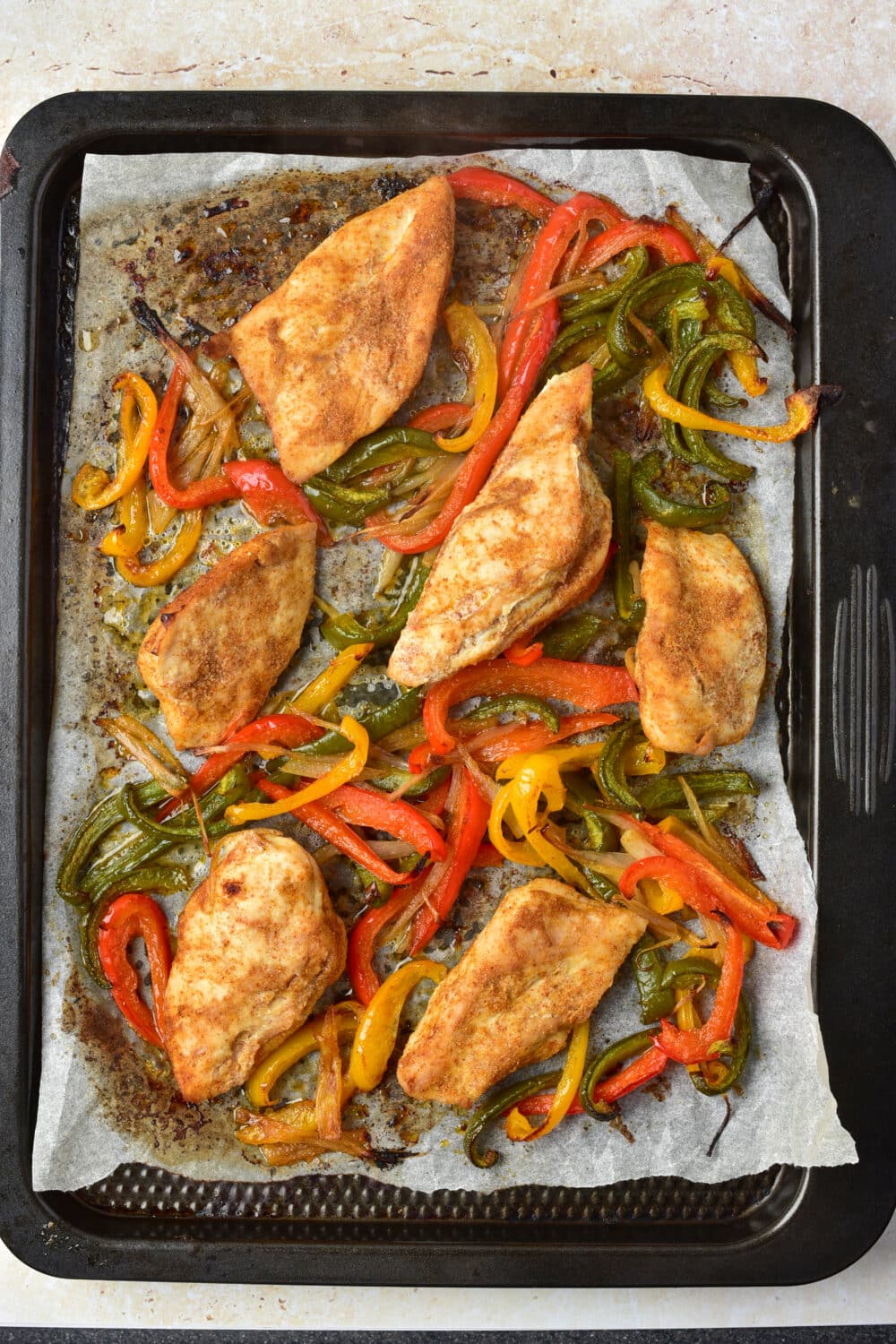 cooked chicken fajitas on sheet pan from the oven