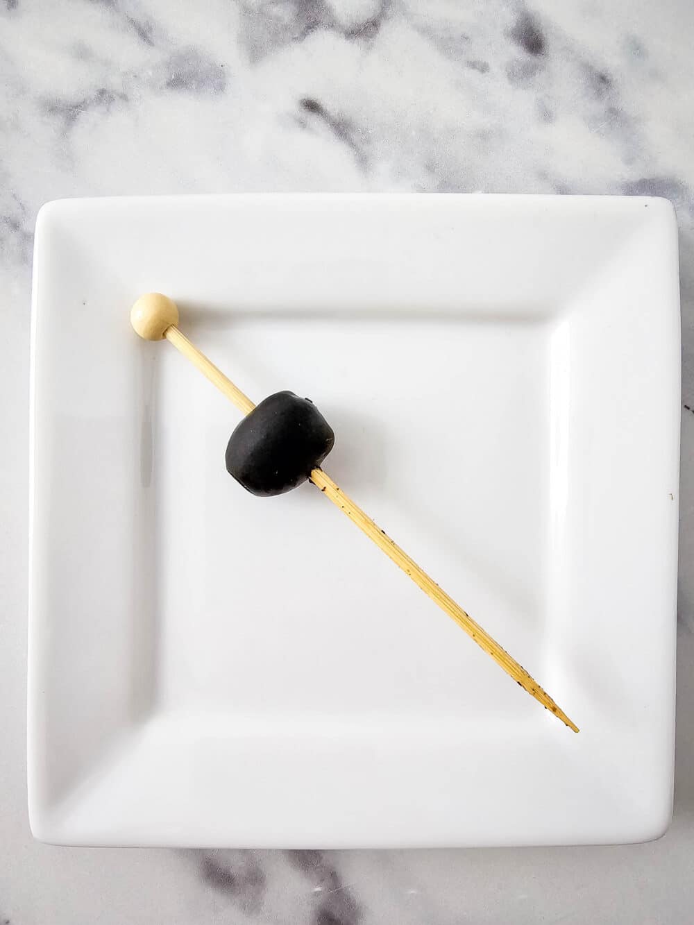one olive on a skewer