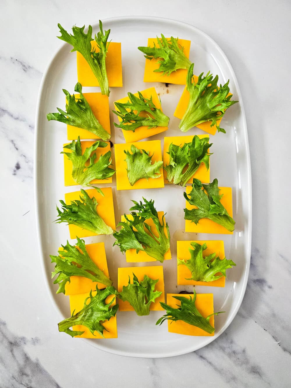 cooked ground beef mini patties topped with cheese and lettuce
