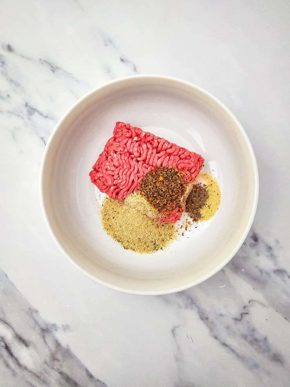 ground beef and spices in a bowl