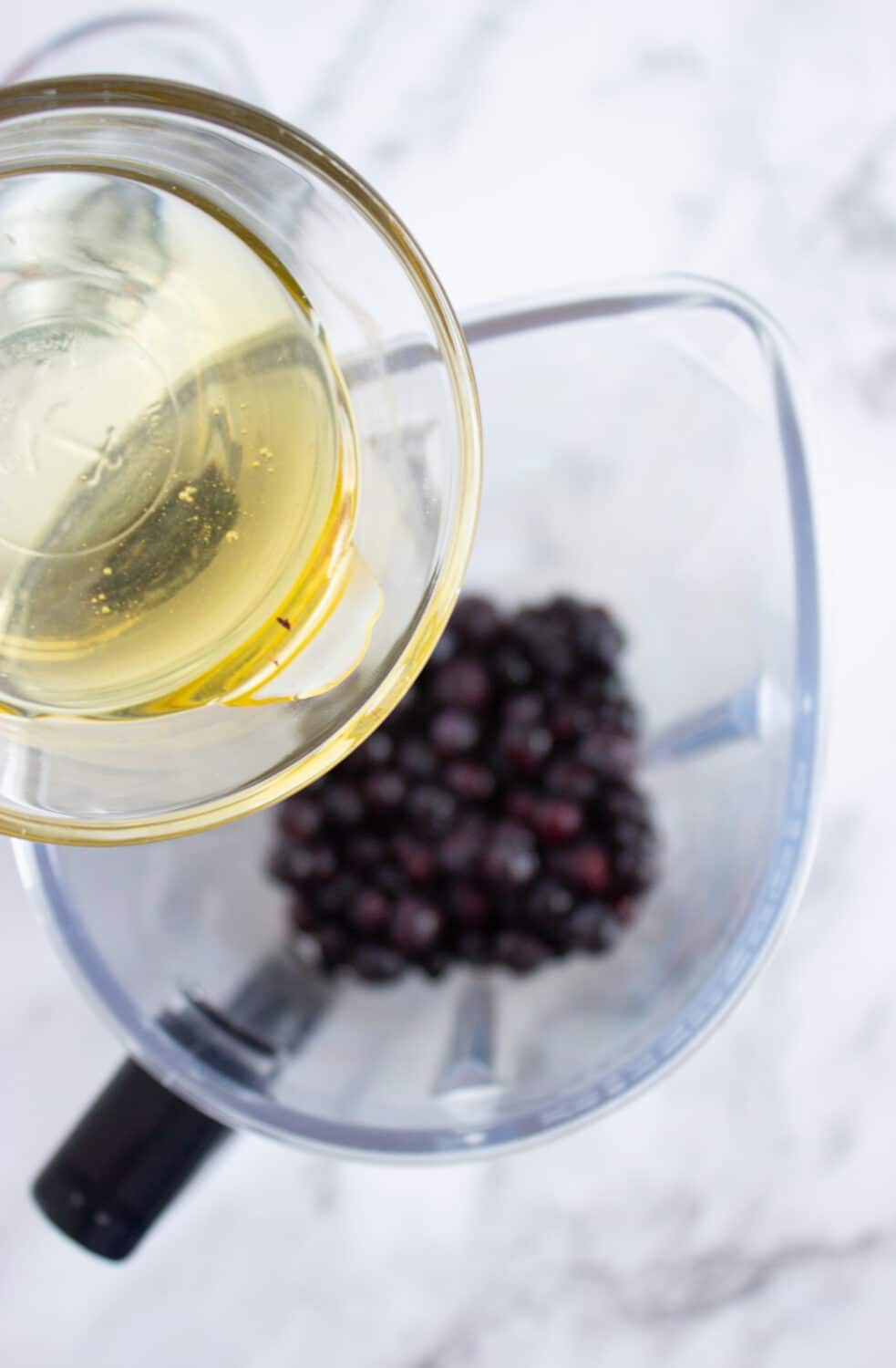 adding sugar-free honey to blueberries in blender