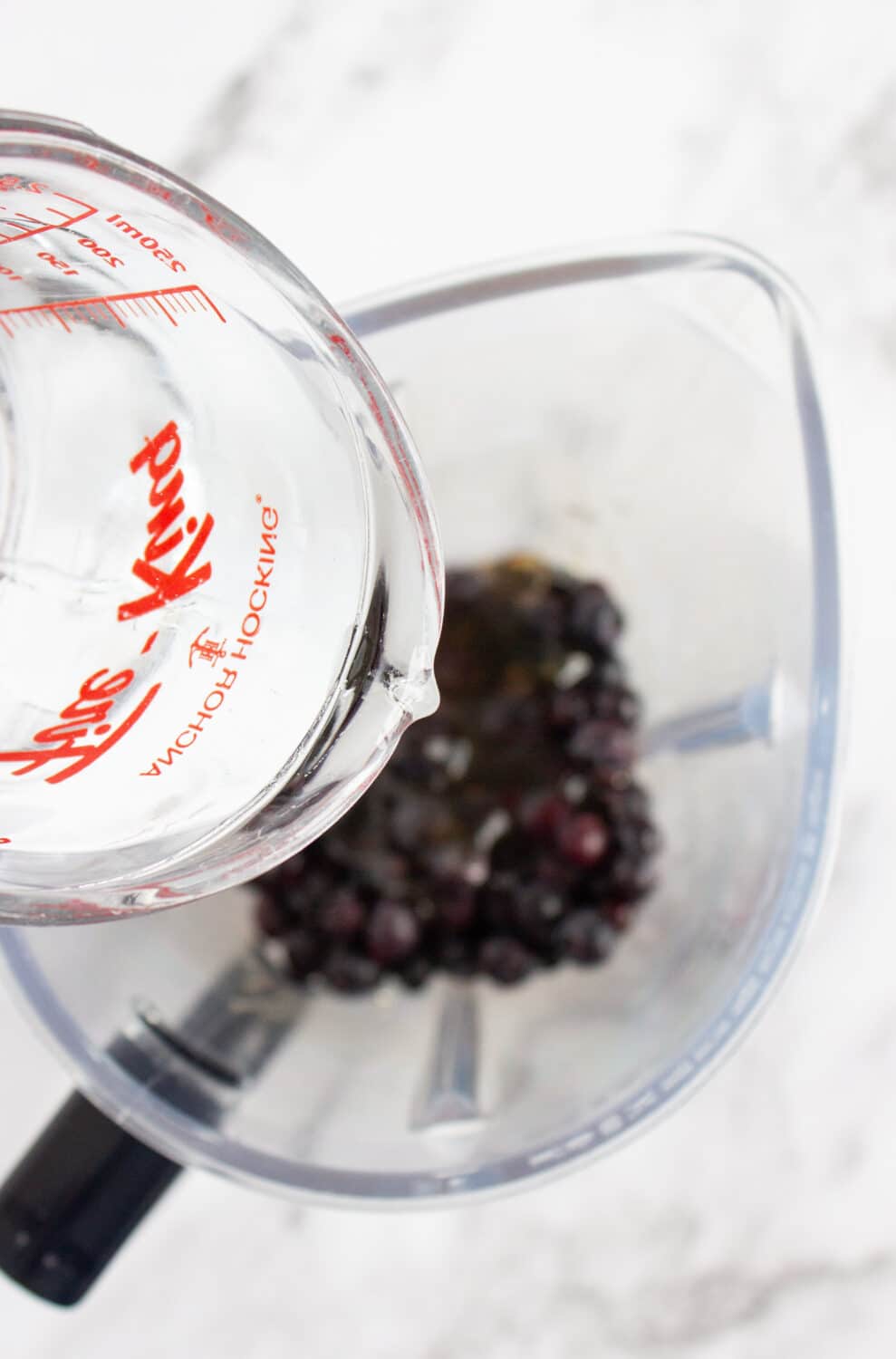 adding water to blueberries in blender