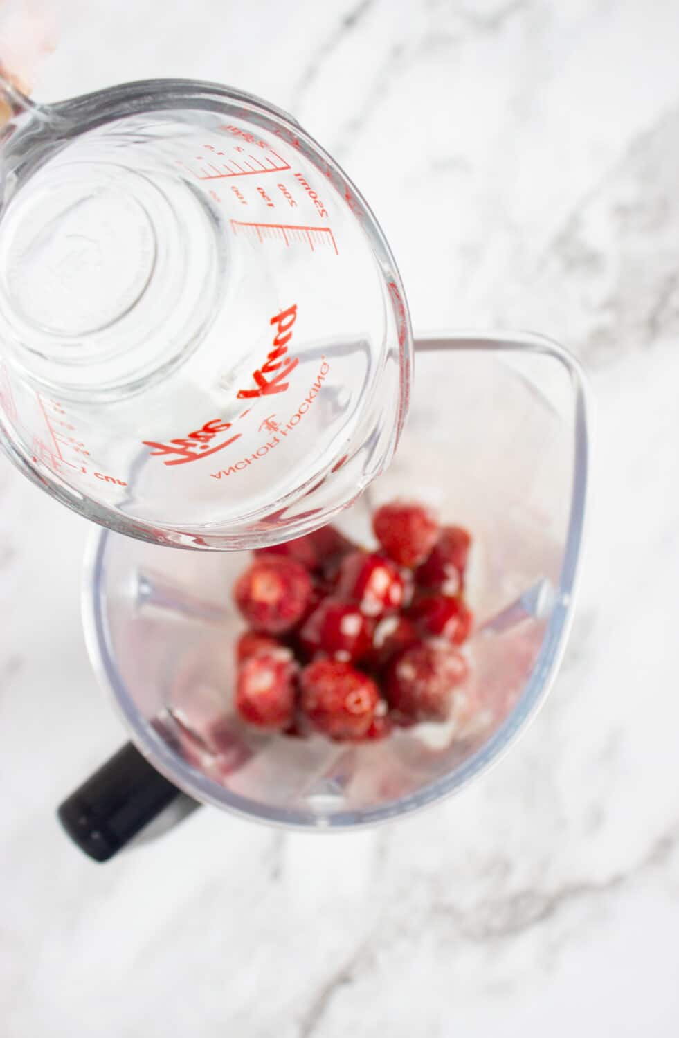 strawberries and sugar-free honey and water in a blender
