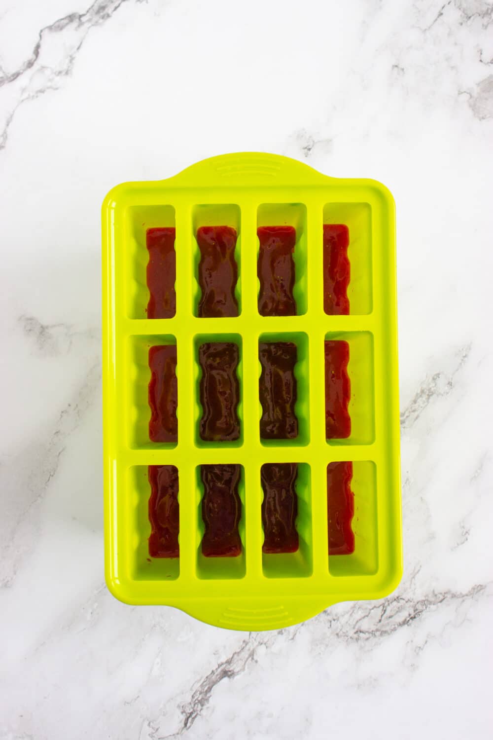 blended strawberry layer in silicone popsicle mold