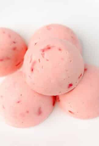 Keto Strawberry Ice Cream Bites stacked on white background
