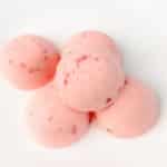 Keto Strawberry Ice Cream Bites stacked on white background
