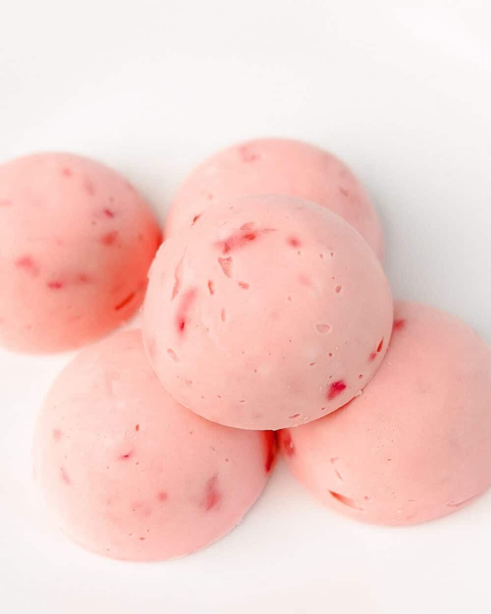 Keto Strawberry Ice Cream Bites stacked on white background