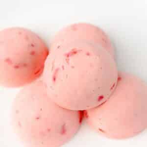 Keto Strawberry Ice Cream Bites stacked on white background