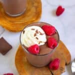 Chocolate Peanut Butter Cottage Cheese Pudding on a wooden board with raspberries