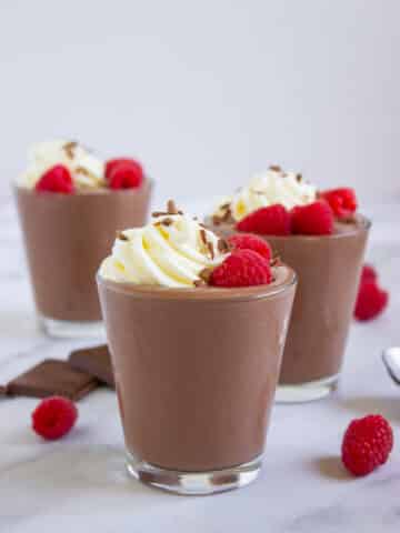 Chocolate Peanut Butter Cottage Cheese Pudding with raspberries and whipped cream on top