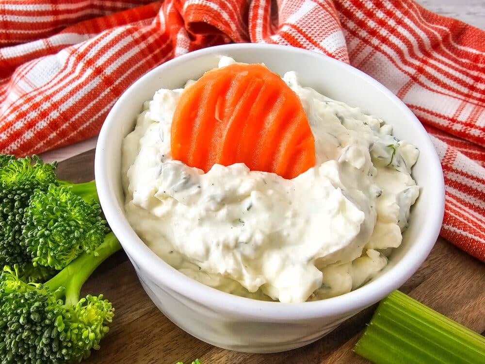 Cream Cheese Veggie Dip with a carrot and broccoli nearby