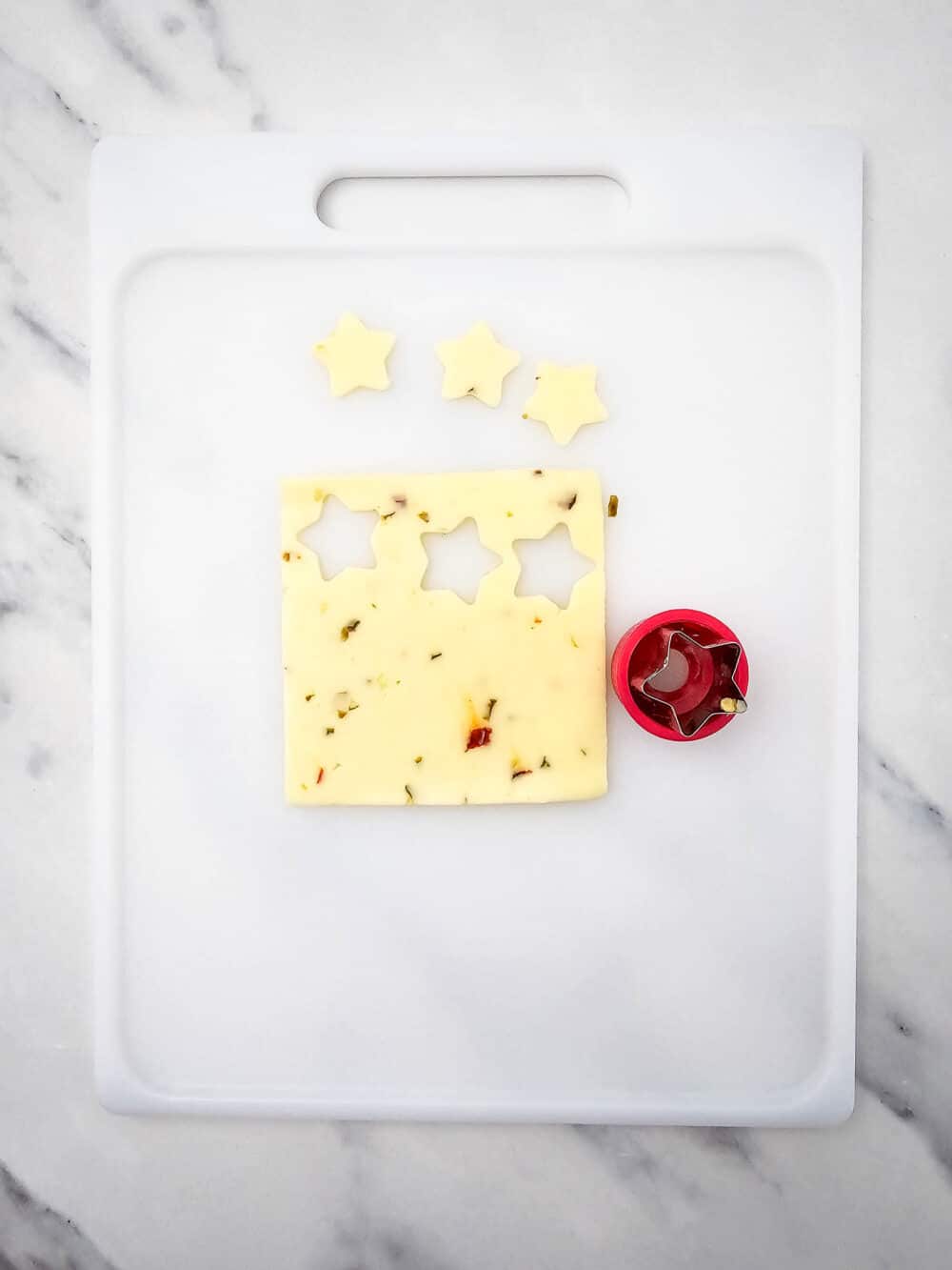 cutting stars out of pepper jack cheese