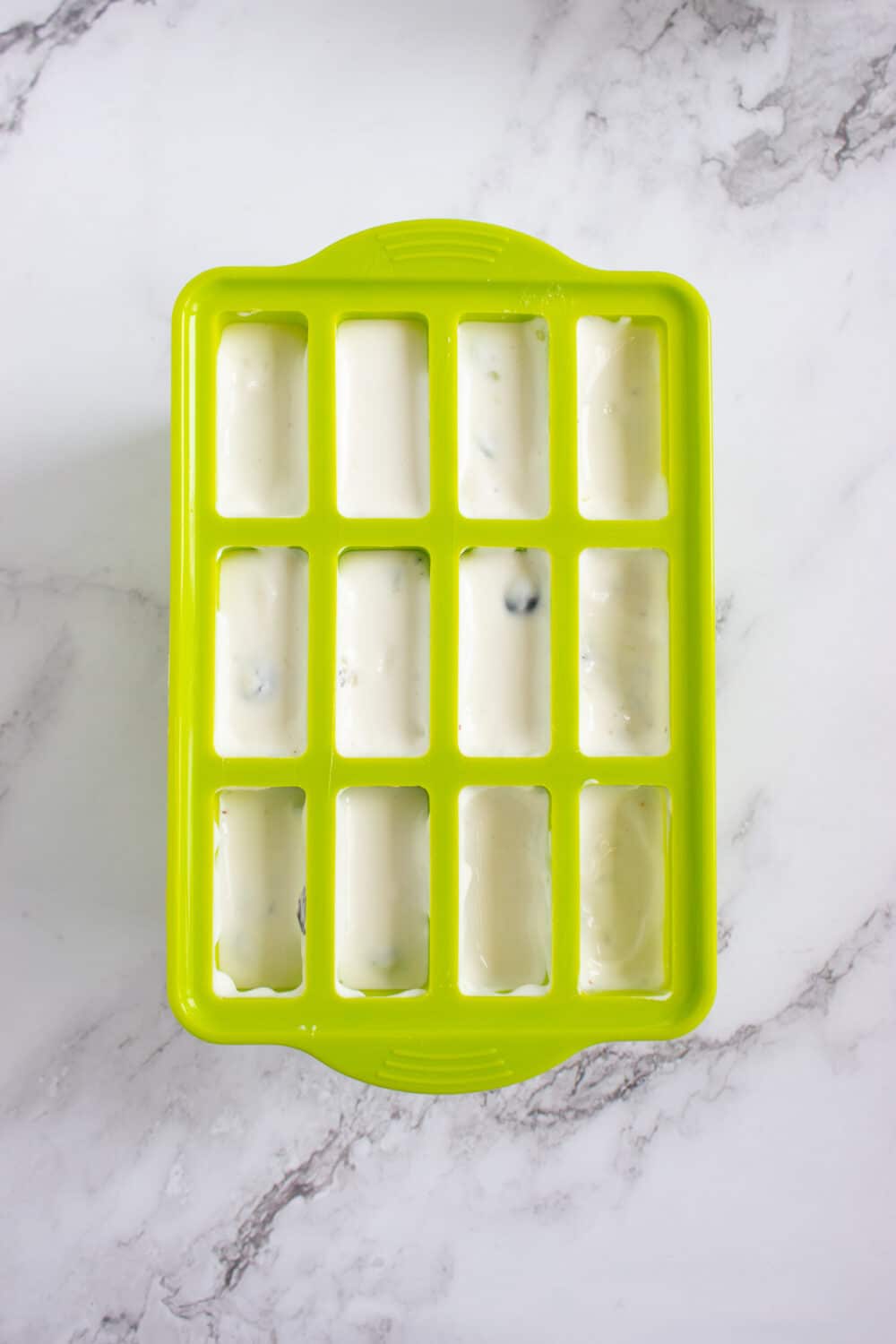 blueberry popsicle filling added to popsicle mold