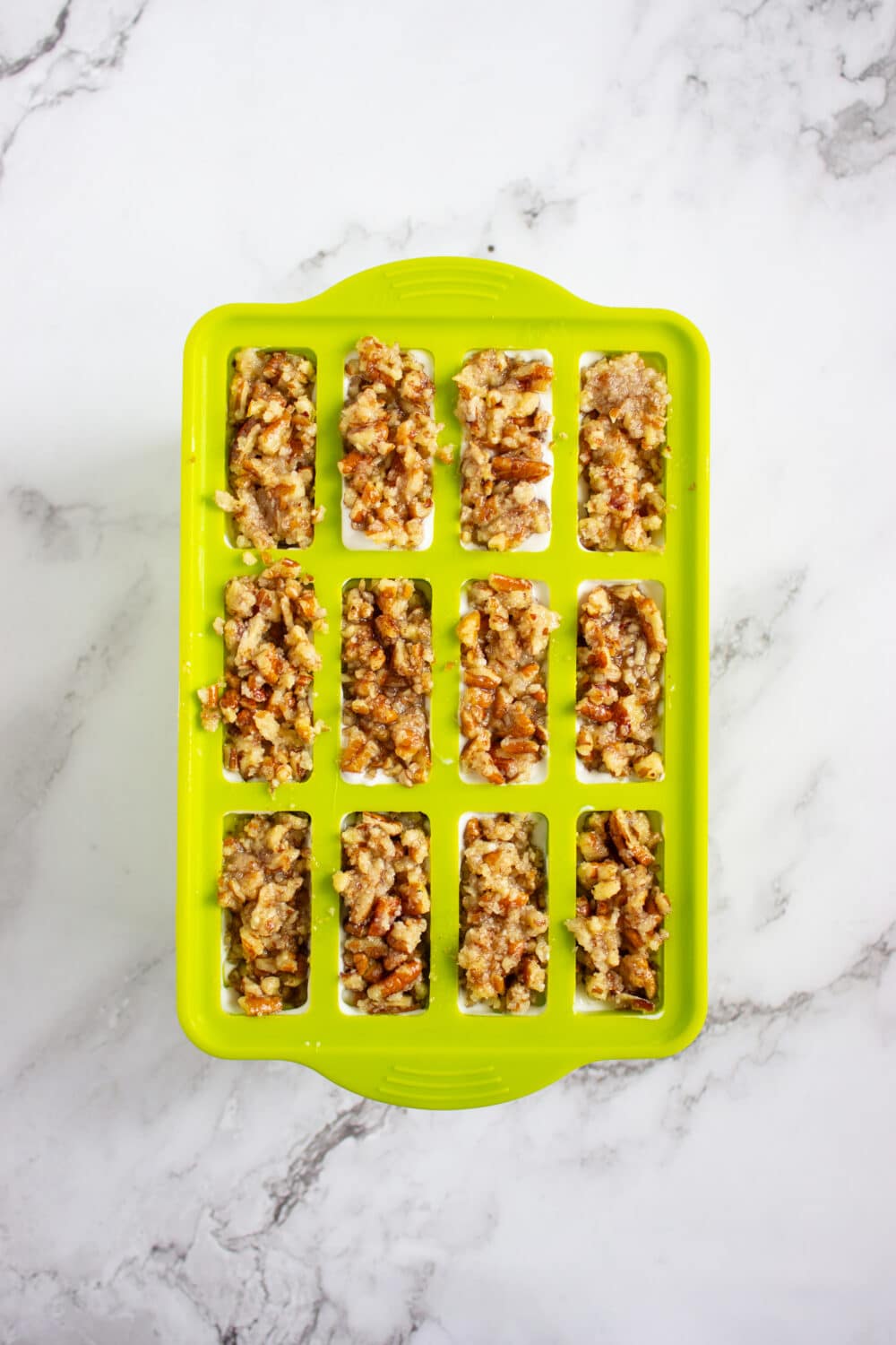 pecan crumble crust added to the popsicle mold