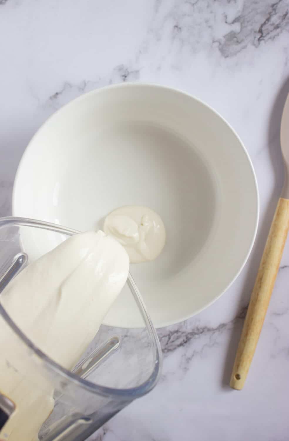 pouring popsicle filling into a bowl