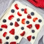 blueberry, strawberry, yogurt bark on a pan with piece taken out