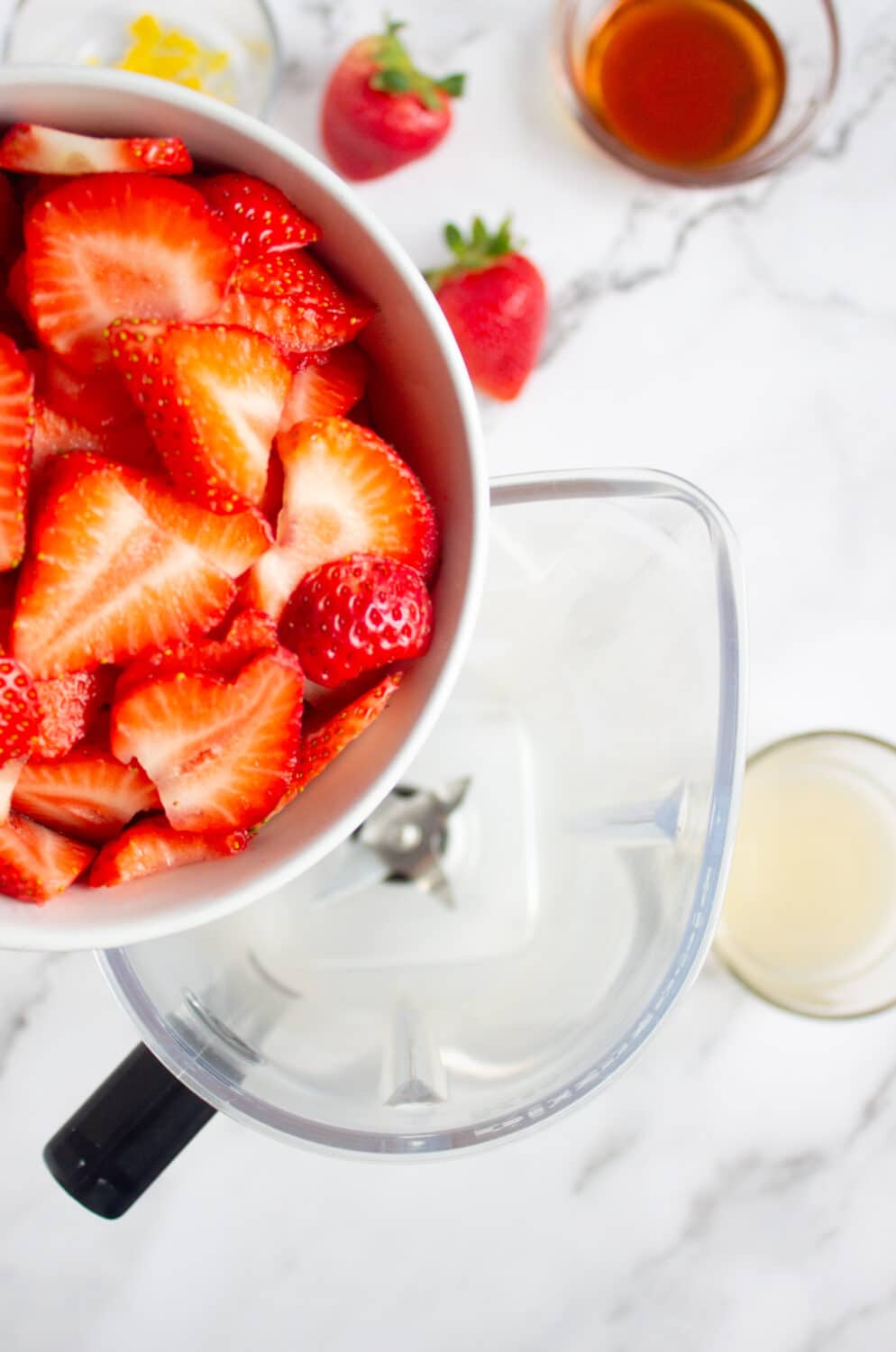 pouring strawberries into a blender