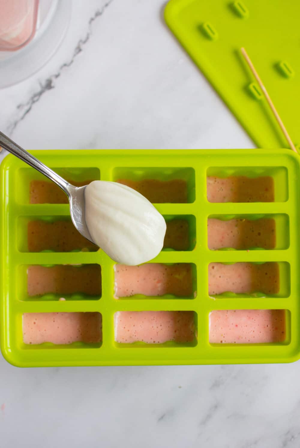 adding greek yogurt to popsicle molds