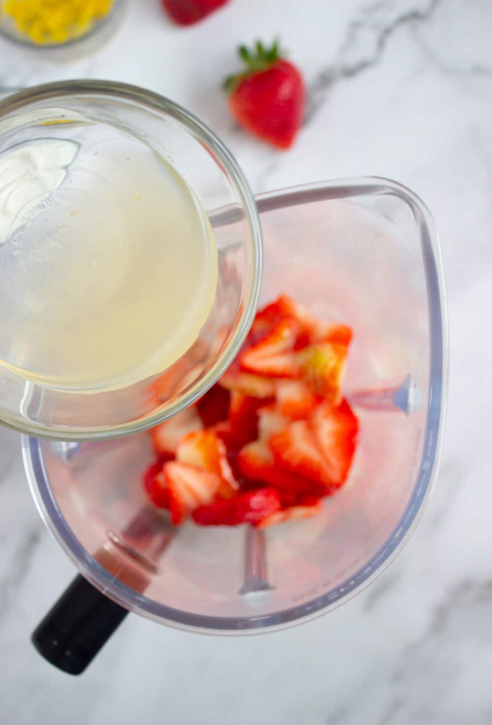 pouring lemon juice into blender