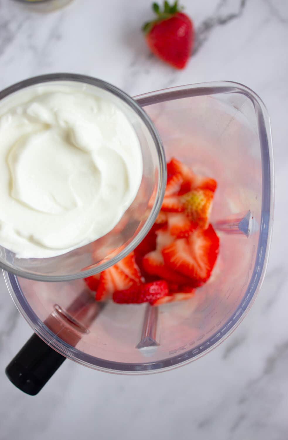 pouring greek yogurt into blender