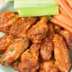 Baked Buffalo Wings with celery and carrots overhead
