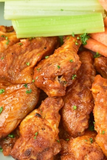 Baked Buffalo Wings with celery and carrots overhead