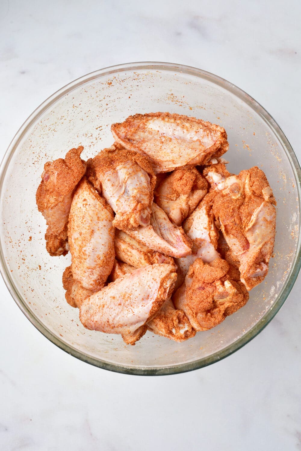 coated raw chicken wings with spices