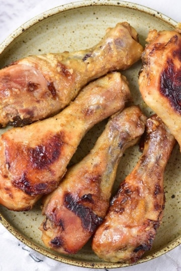 Baked Honey Mustard Chicken Drumsticks overhead view with ketchup and garnish