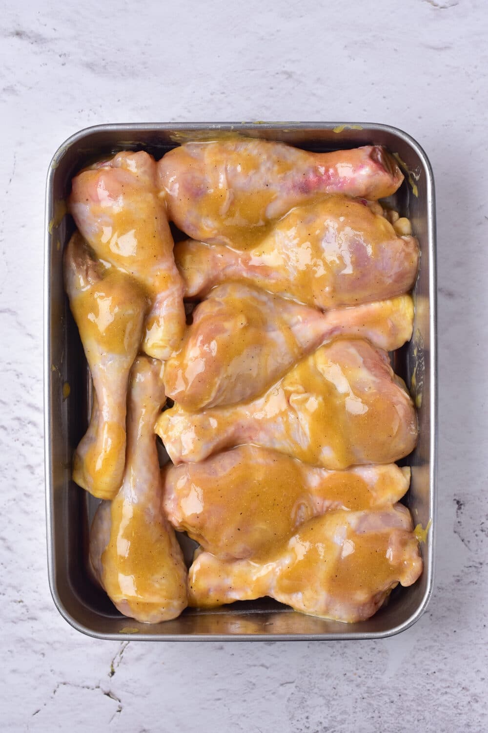 coated chicken drumsticks in a baking dish