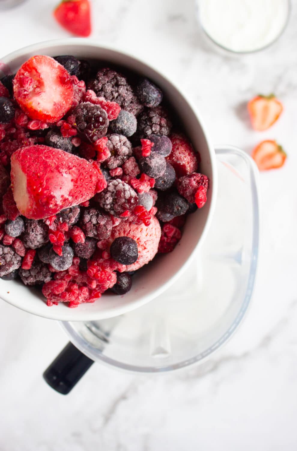 adding berries to a blender