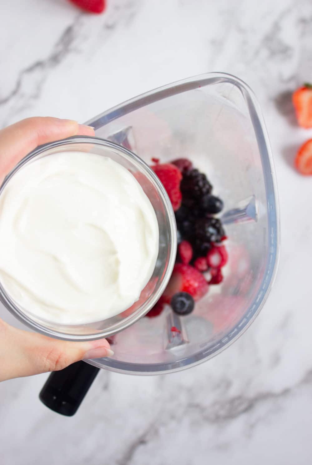 adding Greek yogurt to a blender