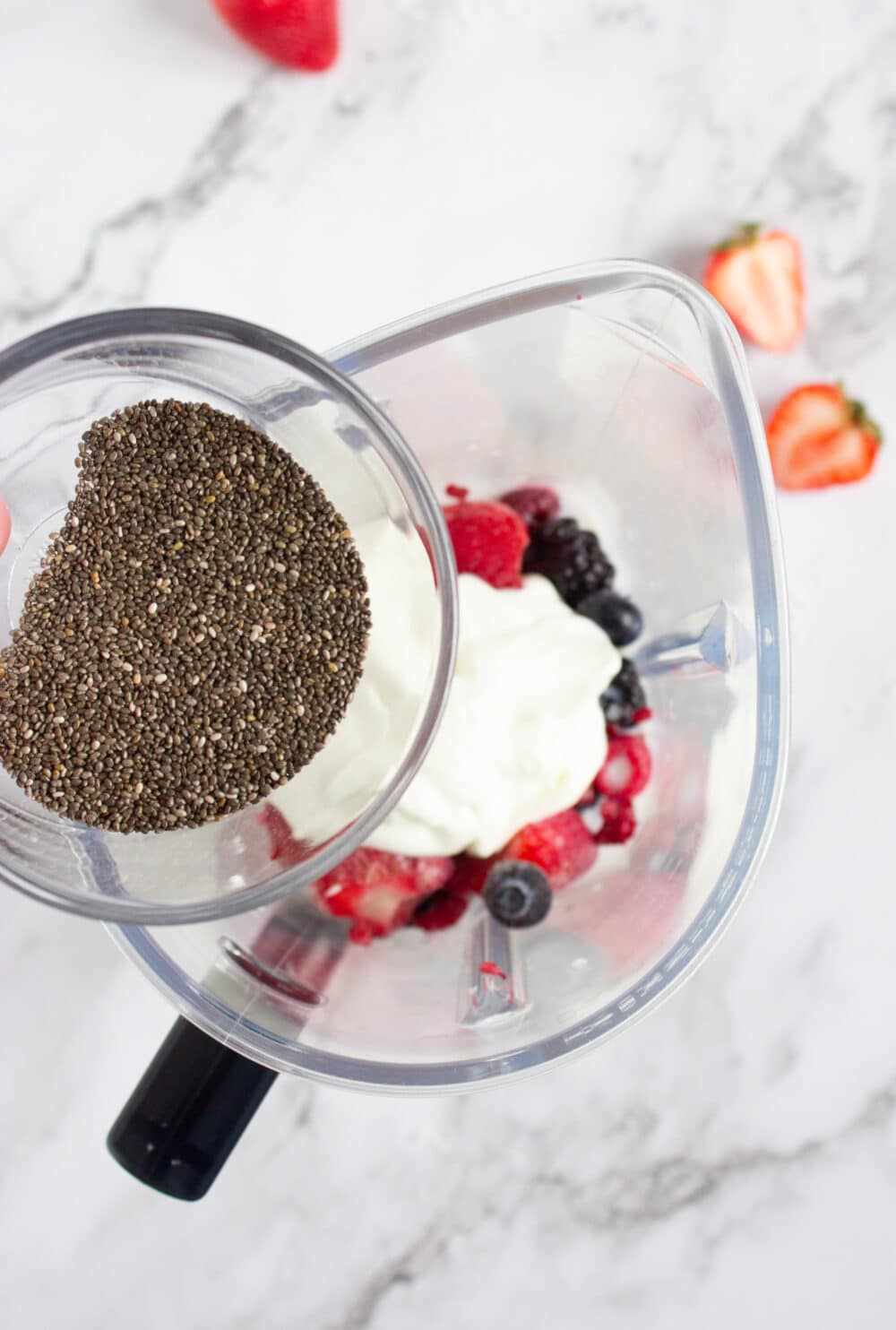 adding chia seeds to a blender