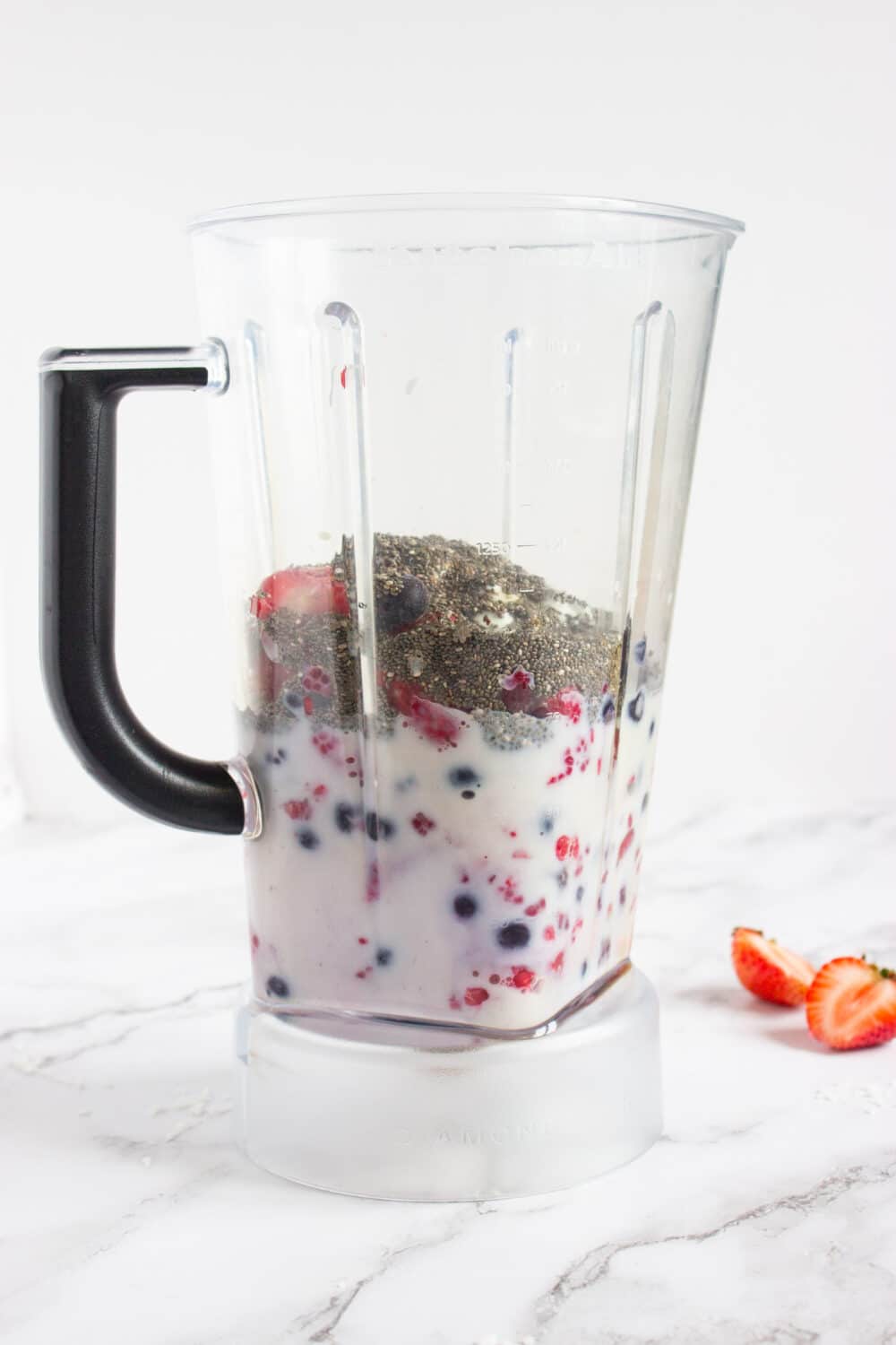 smoothie base ingredients in a blender ready to be blended