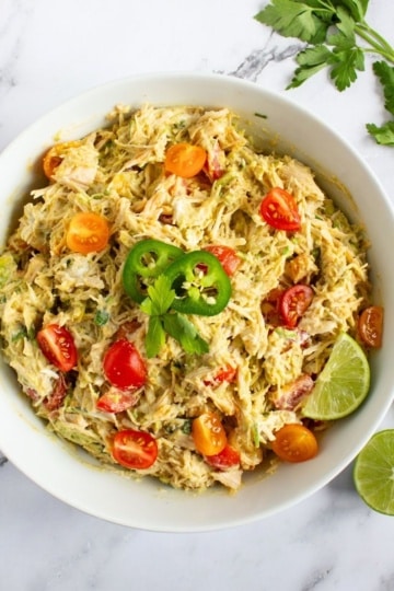 High Protein Chicken Salad with lime slices in a white bowl overhead view