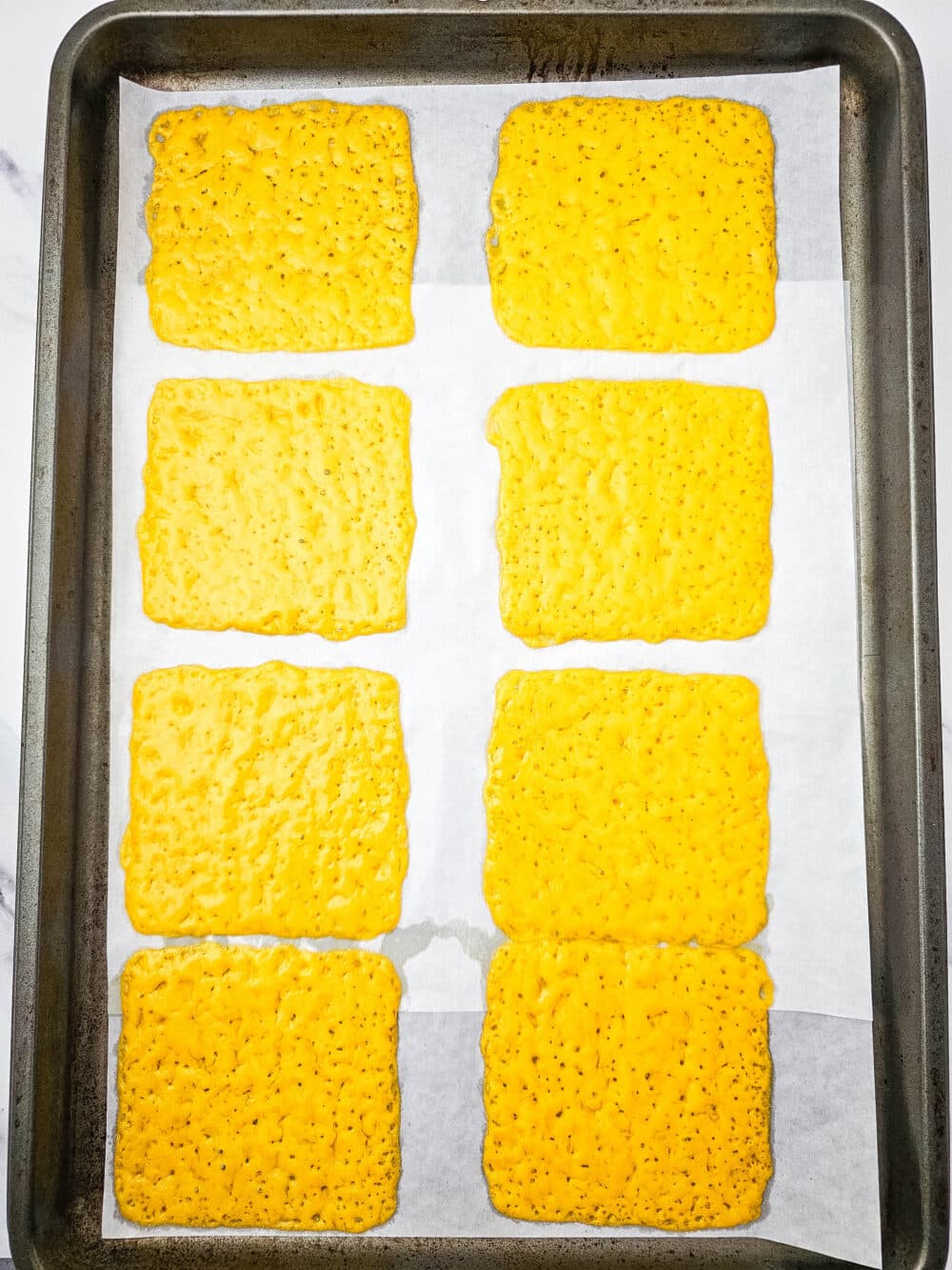 slices of cheese on a baking sheet fresh from oven
