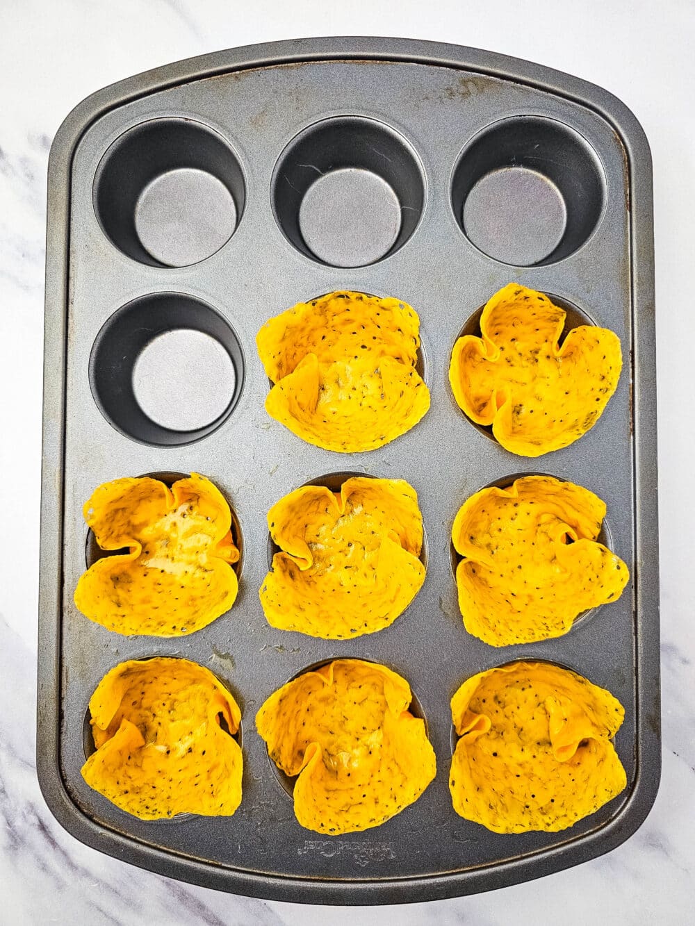 baked cheese fitted into muffin tin