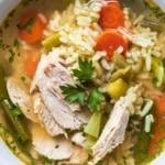 Bone broth chicken soup with rice, carrots, and fresh herbs