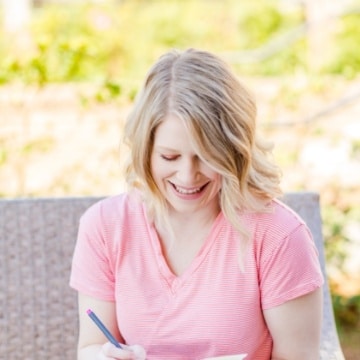 picture of Olivia Wyles looking down writing in a book
