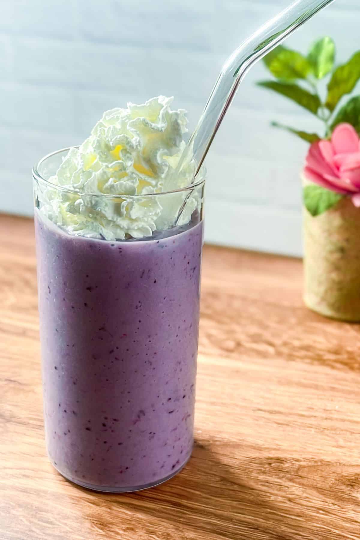 A blended smoothie made with unsweetened almond milk, coconut milk, and frozen mixed berries.
