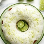 Pinterest pin showing overhead key lime Bundt cake with white glaze and lime zest on a green plate.
