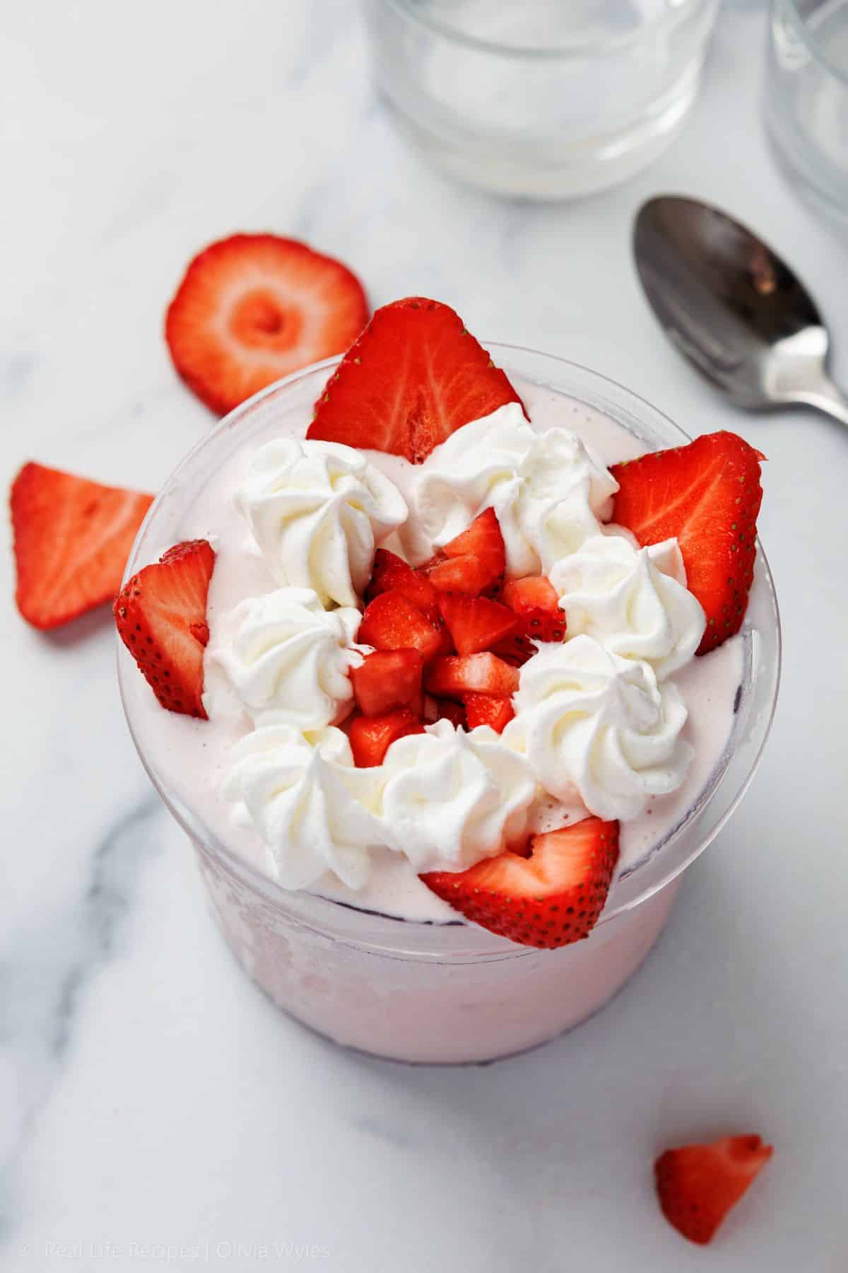 Claude responded: Ninja Creami Strawberries and Cream Protein Ice Cream served in a clear glass cup, topped with swirls of whipped cream and fresh sliced strawberries, on a whit&hellip;Ninja Creami Strawberries and Cream Protein Ice Cream served in a clear glass cup, topped with swirls of whipped cream and fresh sliced strawberries, on a white marble surface.
