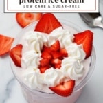 Ninja Creami strawberries and cream protein ice cream topped with whipped cream and fresh strawberries, viewed from above.Ninja Creami strawberries and cream protein ice cream topped with whipped cream and fresh strawberries, viewed from above.