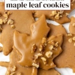 Glazed maple leaf cookies topped with chopped walnuts on a white plate, text overlay reads maple leaf cookies.