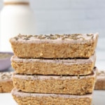 Stack of four honey lavender protein bars showing the crumbly base and pink glazed lavender top layer.